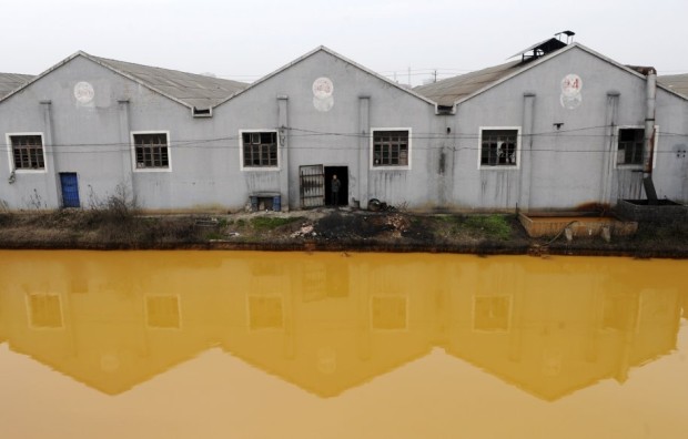a-manufacturer-of-screws-and-nuts-is-situated-next-to-a-polluted-river-in-jiaxing-zhejiang-province