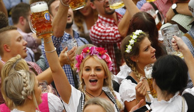 A young woman celebrates the opening of the 182. Oktoberfest beer festival in Munich, southern Germany, Saturday, Sept. 19, 2015. The world's largest beer festival will be held from Sept. 19 to Oct. 4, 2015. (AP Photo/Matthias Schrader)