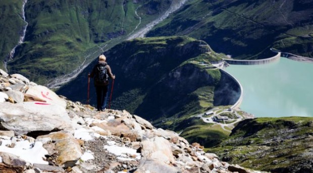 MOOSERBODEN, AUSTRIA - AUGUST 22: Young woman hiking on a trail down to the mountain reservoir Mooserboden on August 22, 2014, in Mooserboden, Austria. (Photo by Thomas Trutschel/Photothek via Getty Images)***Local Caption***