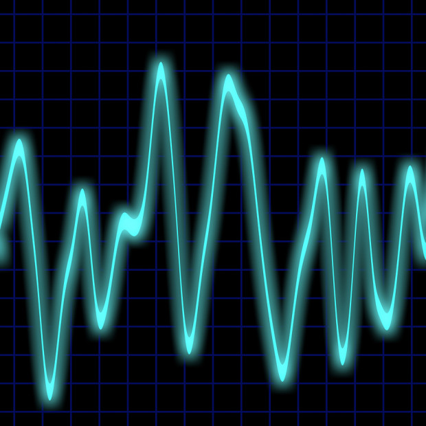 Irregular heartbeat on a neon blue monitor