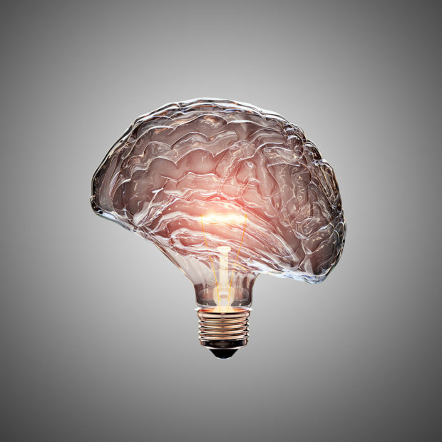 Glowing Light Bulb with the glass shaped as a Brain. This 3D illustration is conceptual of an active, creative, thinking mind or idea.