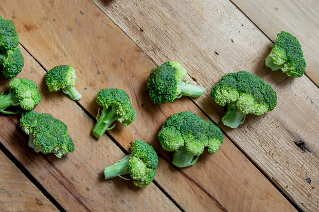 Broccoli. Green broccoli. Raw broccoli on wooden background.