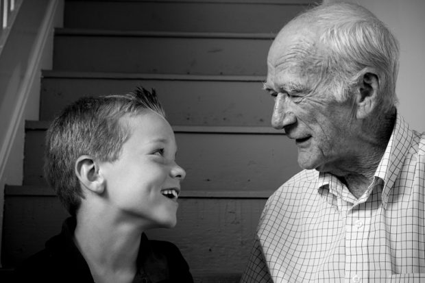 Black and white portrait of a grandpa with his happy grandson.