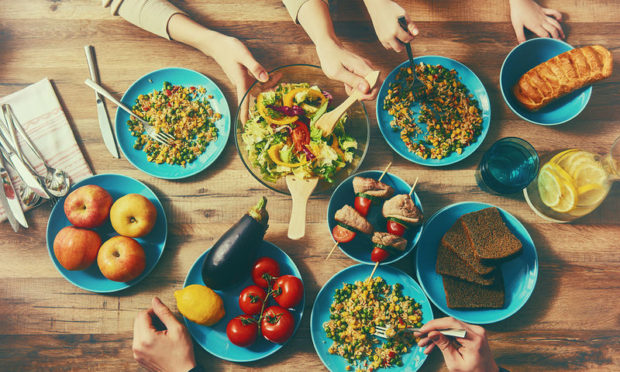 bigstock-top-view-of-family-having-dinn-118563533