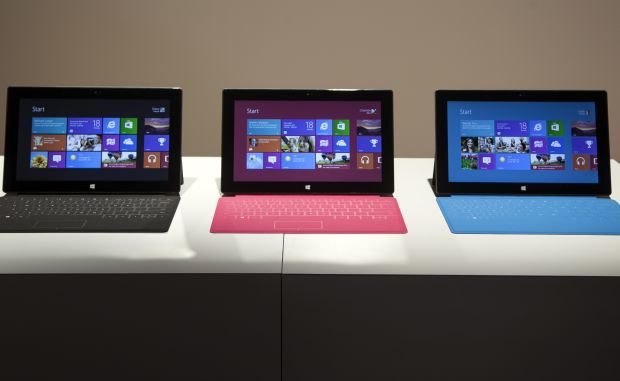 Microsoft Corp.'s Surface tablet computers, aiming to compete with Apple's iPad, are displayed at Hollywood's Milk Studios in Los Angeles Monday, June 18, 2012. The 9.3-millimeter thick tablet comes with a kickstand to hold it upright and keyboard that is part of the device's cover. (AP Photo/Damian Dovarganes)